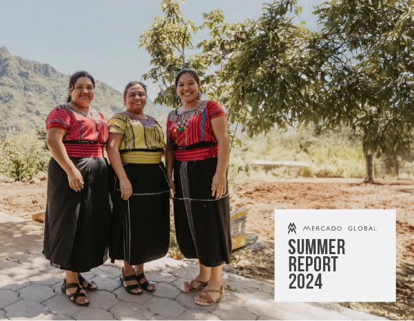 Three artisans stand together, pose in front of a grassy landscape. Textbook says 