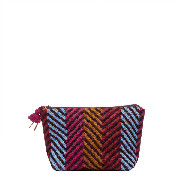 Front of the artisan hand woven Mini Cristina Cosmetic Pouch in Winter Berry. The Winter Berry has diagonal stripes in blue, red, and yellow ochre columns. It has a mini red tassel and a leather zipper pull.