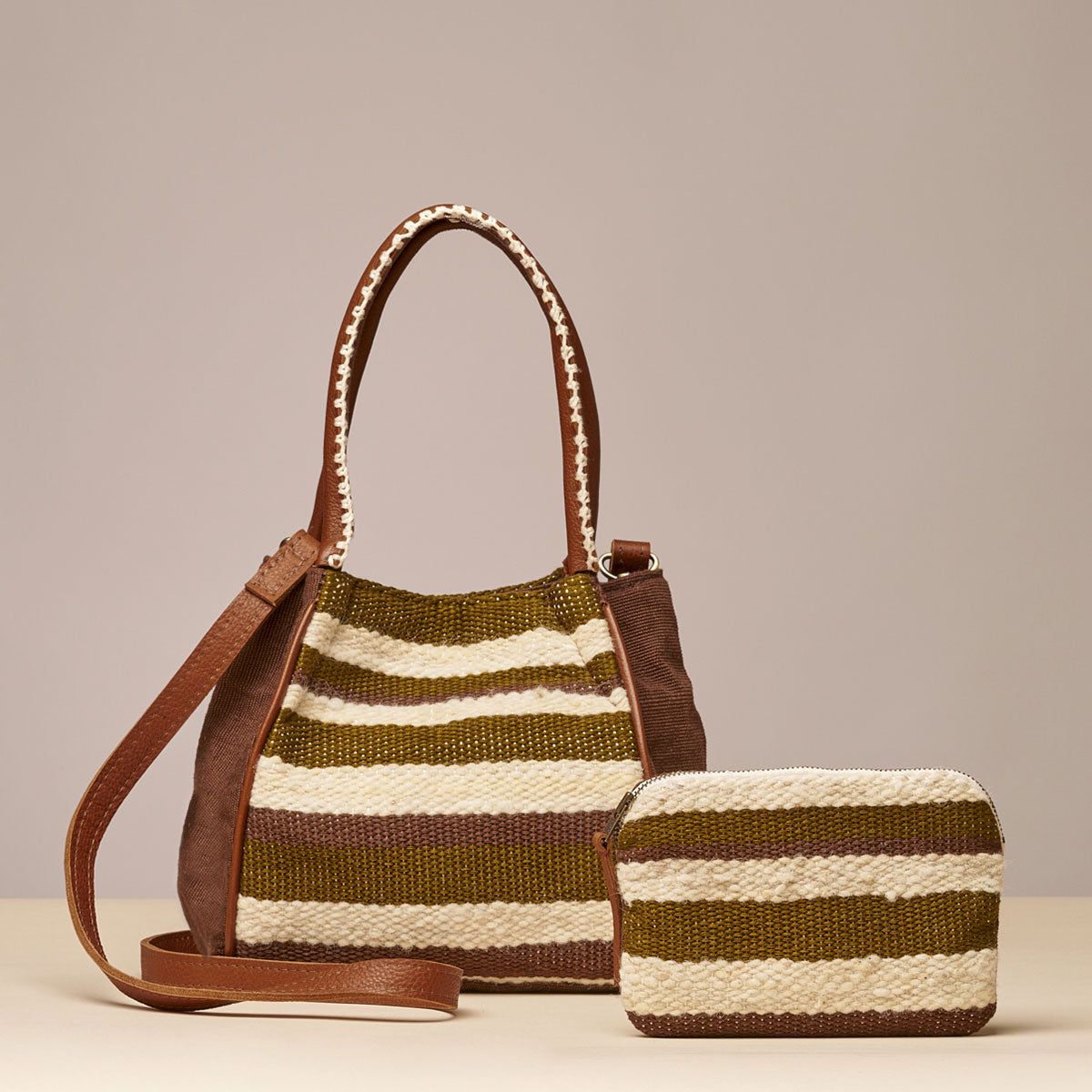 Teresa Wallet and Flora Petite Tote in Forest pattern. The Forest pattern has horizontal green and beige stripes. The Flora Petite crossbody has leather straps and embroidered detailing on the handles. The Teresa wallet has a leather zipper pull.