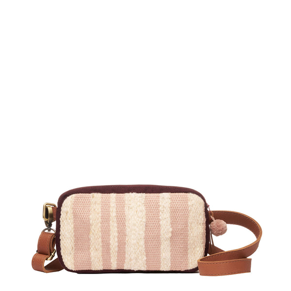 Front of the hand woven artisan Felipa Belt Bag in Snow pattern. The pattern has vertical pale pink and beige stripes. it has a detachable leather strap and a pink zipper pompom.