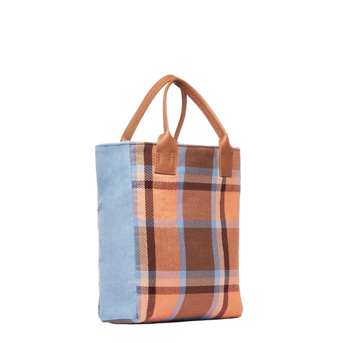 Hand woven artisan Ana Tote in Brickstone pattern. The Ana Tote is placed at an angle to show the sky blue sides. The brickstone pattern is an orange, brown, and sky blue plaid. It has leather handles. The Ana Tote is tall, rectangular-shaped.