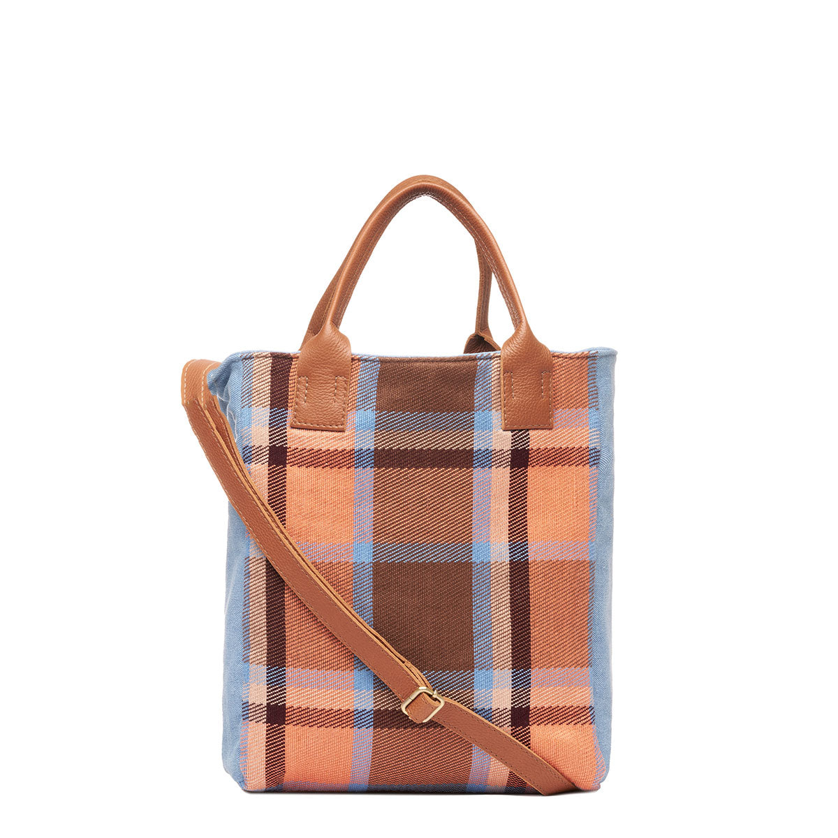 Front of hand woven artisan Ana tote in Brickstone pattern. A leather adjustable strap hangs diagonally over the front. It has leather handles. The Brickstone pattern is a brown, orange, and sky blue plaid.