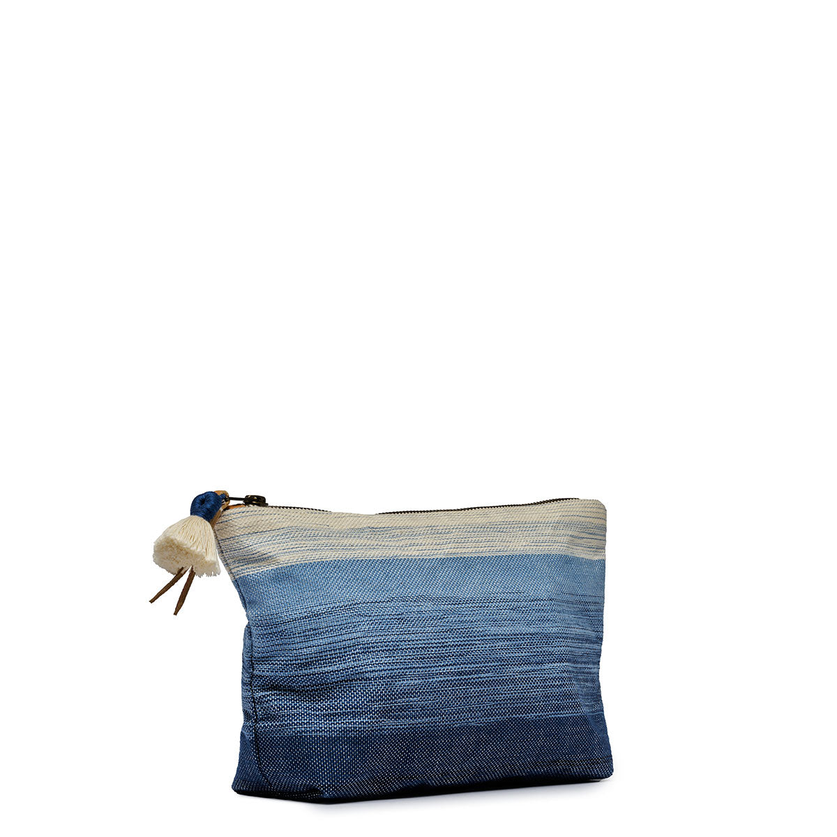 A left-sided view of the Cristina Pouch in Ocean Breeze. It has a gradient woven pattern white to dark blue. It has a white tassel and leather zipper pull.