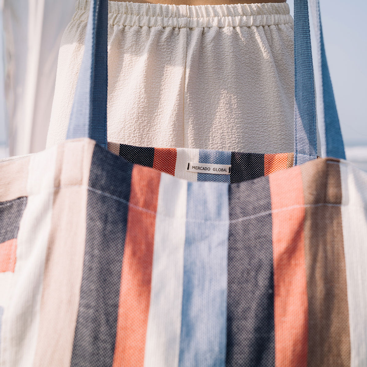 Close up of a model holding the Blanca Tote in Blue Canyon.