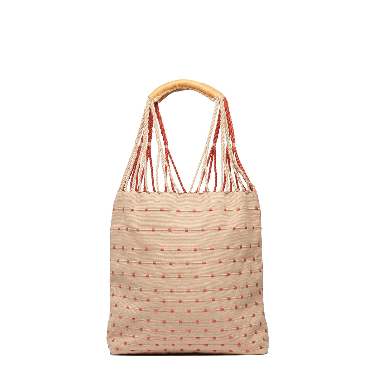 Back view of the Apolonia Tote in Desert Sands. It has a reverse pattern on the back, beige and pink dots. It has thread wrapped cord handles.