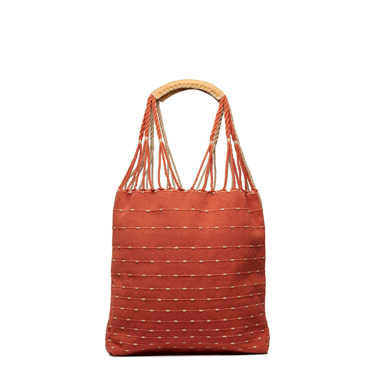 Front view of the Apolonia Tote in Desert Sands. The pattern is coral pink with horizontal beige dots. It has thread wrapped cord handles.