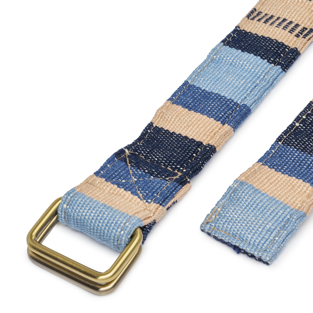 A close up of the brass buckle detail of the Celeste Belt in Skyscape.