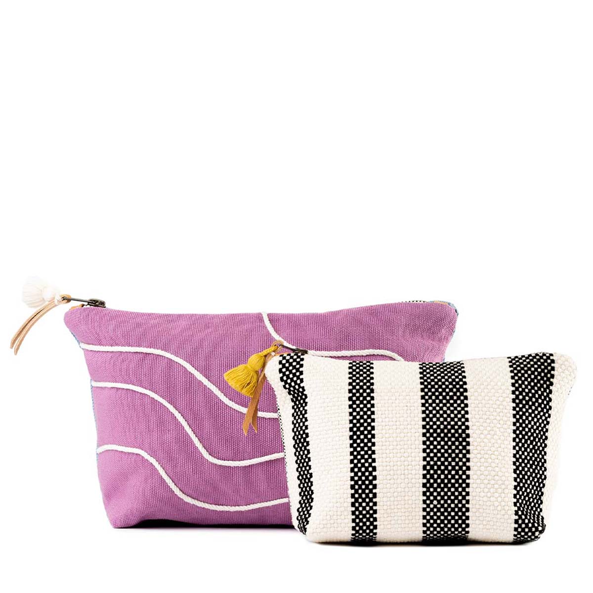 Both the hand woven artisan Cristina Cosmetic Pouch in Cosmic Waves pattern and the Mini Cristina Cosmetic Pouch in Tourmaline pattern are shown together, the Mini Cristina placed in front.