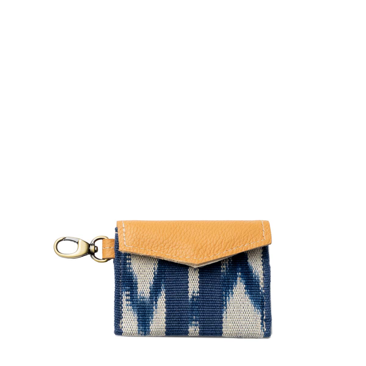 The front of the hand woven artisan Chabela Card Holder in Atitlán Hills pattern. It has vertical and chevron dark blue and white stripes, leather flap, and a brass claw clip.