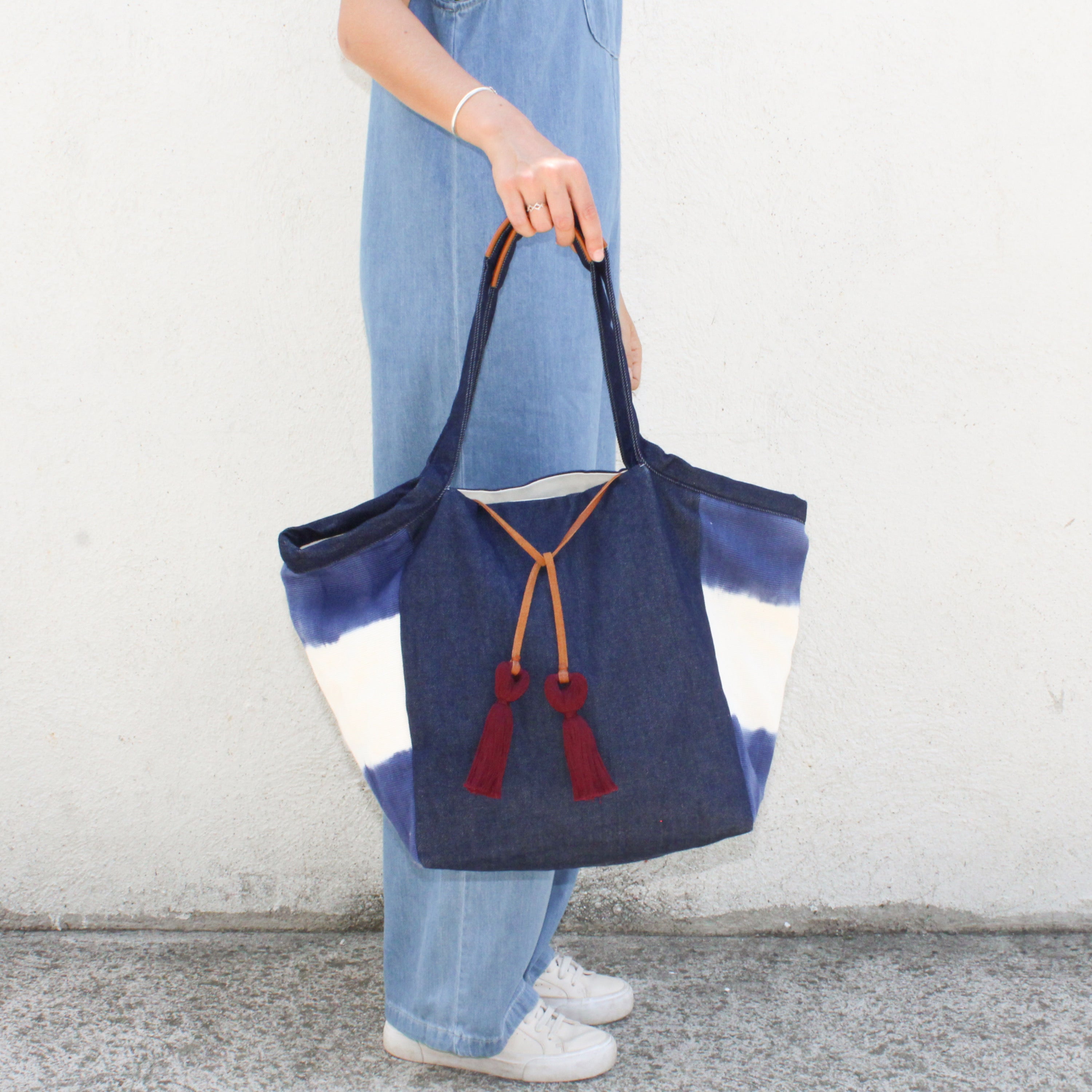 A model holds the Rosa Tote in Denim Dip-Dye.